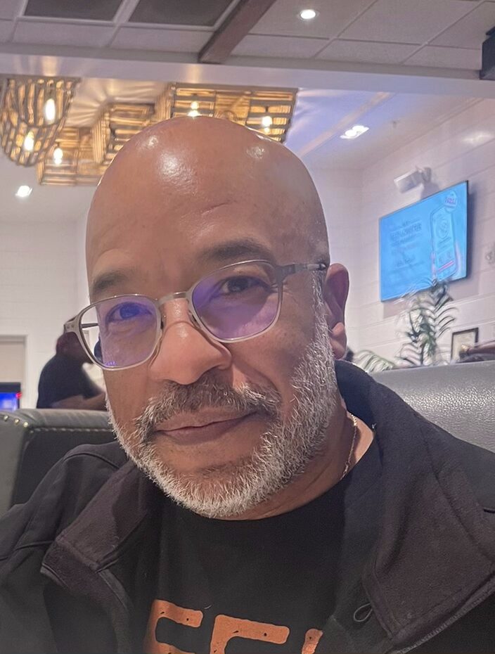 Older man with bald head and neat grey facial hair